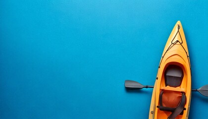 Bright orange kayak with blue background with copy space

