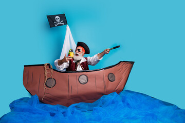 Photo of dangerous robber funny pirate swimming sea wave isolated on blue color background