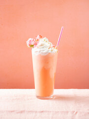 Strawberry, rose milk shake, smoothie, cocktail with whipped cream topping. Pink background. Copy...