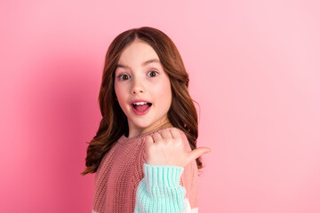 Cheerful young girl in stylish sweater with vibrant expressions against a pink background, showcasing youthful charm