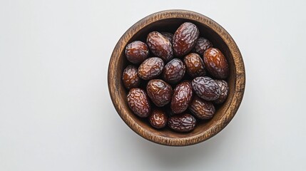 Obraz premium Dates in wooden bowl, white background, healthy snack