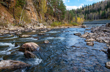Southern Urals, a rapids on the mountain river Aigir. The reinforced river shore at the railway station.