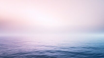 Obraz premium Tranquil ocean view with soft pastel colors reflecting in gentle waves under a hazy, ethereal sky, creating a peaceful scene