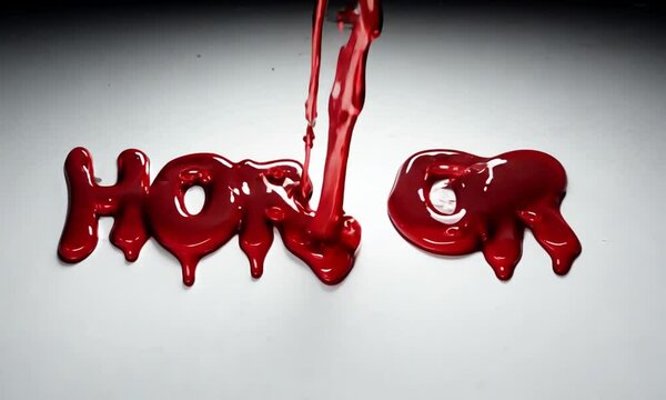 An eerie image captures the text "HORROR" spelled out in dripping, blood-red liquid against a stark white background.