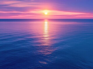 Obraz premium Stunning sunset over tranquil ocean. Vibrant colors reflected in the water