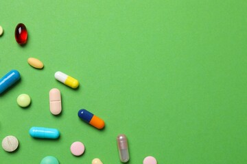 Various pills on color background, top view