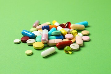 Various pills on color background, top view