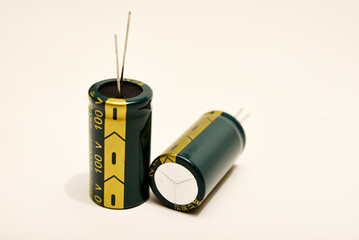 Electrolytic capacitors on a white background. Electronic elements for electronic devices.