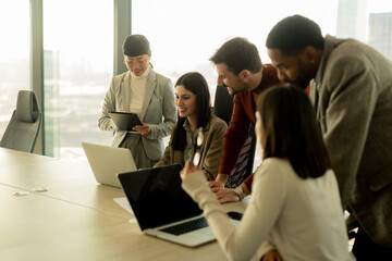 Fototapeta premium Collaboration thrives in a modern office with stylish professionals engaged in discussion