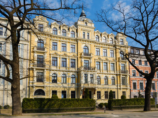 A old  beautifully ornate Art Nouveau building facade, including decorative balconies, elegant...