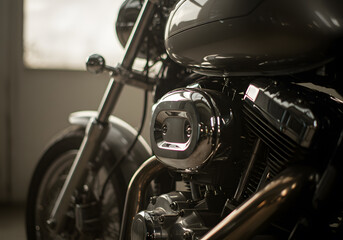 Close-up of a gleaming chrome motorcycle engine, reflecting light in a garage setting