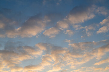 Serene Cloudscape with Softly Lit Sky at Sunset or Sunrise