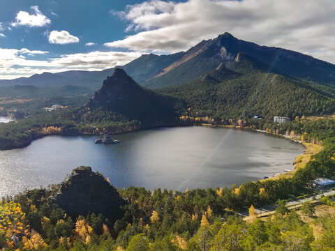 Beautiful landscape of tranquil lake surrounded by lush forests and mountains. National nature park Burabay, Kazakstan.