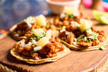 Traditional Mexican Tacos al Pastor with Fresh Lime and Salsa on a Rustic Table