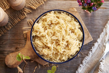 Fermented cabbage or sauerkraut in a bowl, top view