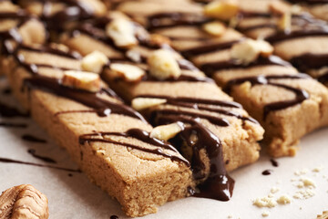 Homemade chocolate bars made of whey protein powder, ground oat flakes, maple syrup and nut butter