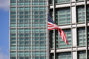 US flag on modern building facade. Symbol of United State of America