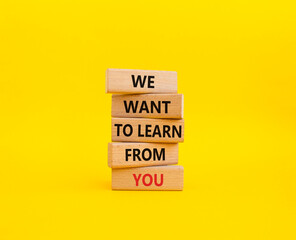 We want to learn from you symbol. Wooden blocks with words We want to learn from you. Beautiful yellow background. Business and We want to learn from you. Copy space.