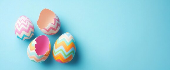 Easter concept: a cracked open Easter egg with a pastel-colored zigzag pattern on a blue background