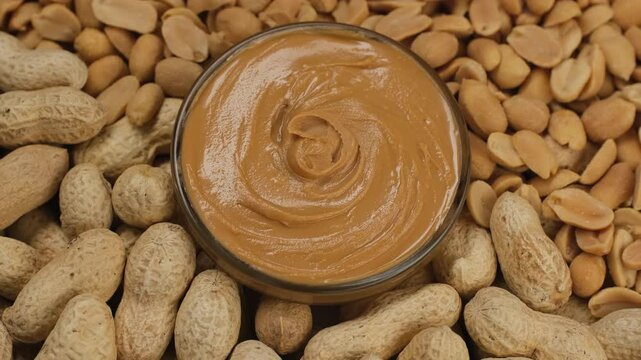 Heap of peanuts, peanut butter and peanut in shell, rotation