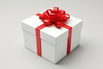 Obraz premium A white square gift box adorned with a vibrant red ribbon, symbolizing celebration and gifting.