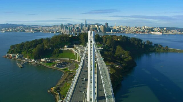 Flying above the San Francisco Oakland Bay Bridge during rush hour. Yerba buena and Treasure Island in the background. Financial District skyline. California, US. Shot in 8K.