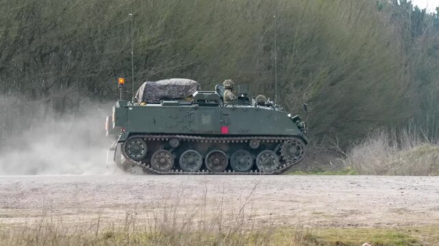 soldier commanding a british army Bulldog FV432 tank in motion, Wiltshire UK