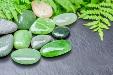 Elegant arrangement of polished green jade stones, soft moss, and delicate fern leaves creates a natural and calming aesthetic in a serene setting