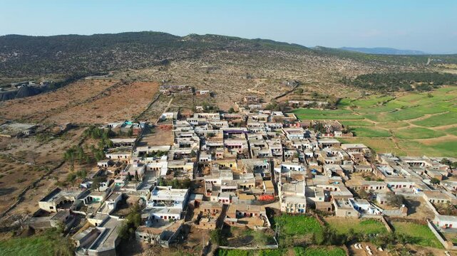 Aerial view of village between hills in Chakwal, Pakistan.