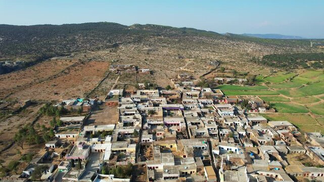 Aerial view of village between hills in Chakwal, Pakistan.