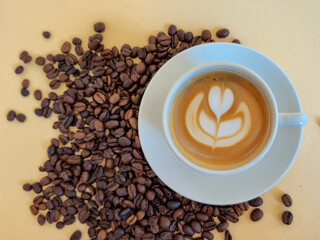 An Artistic Coffee Cup Beautifully Displayed Surrounded by Freshly Roasted Coffee Beans