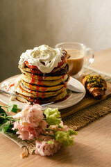 romantic breakfast with croissants and pancakes and whipped cream