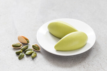 Pistachio cream quenelles. On a plate. Close-up