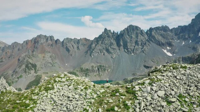 Ambar Lake, located on the peaks of the Ka&ccedil;kar Mountains, is seen with a rising drone camera. The rocky peaks, bowl structures bearing glacial traces and the turquoise color of the lake are visible.