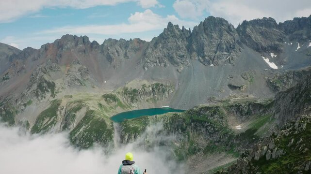 A hidden blue above the clouds, in the shadows of the peaks: Ambar Lake. A moment alone with nature in the silence of the Ka&ccedil;kars. As the drone comes back, a mountain climber enters the frame.