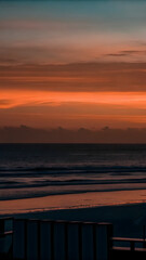 Fototapeta premium A warm sunset over a minimalist ocean soft orange