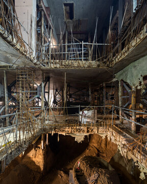 Construction site with layers of concrete and exposed reinforcing bars