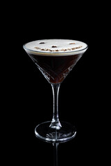 Espresso Martini cocktail in a glass on a black background