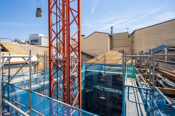 Urban construction site with crane and scaffolding