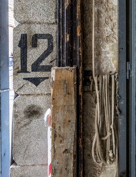 Industrial wall with peeling paint and coiled rope details