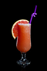 Grapefruit lemonade in a glass on a black background