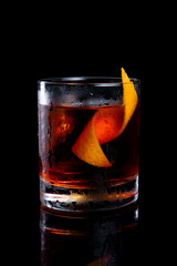Campari Negroni cocktail in a glass on a black background