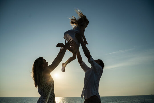 Family enjoying a sunset beach moment in Italy