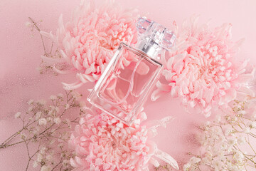 Elegant perfume bottle amidst delicate pink flowers background