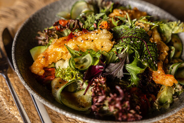 Fresh green salad with crispy king prawns in batter