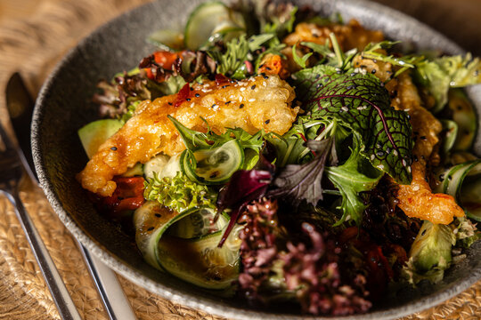 Fresh green salad with crispy king prawns in batter