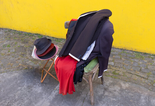 Tango dresses and hats displayed on chairs in El Caminito, Buenos Aires