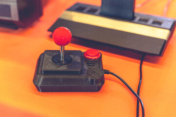 Retro Gaming Joystick and Classic 80s Console Close-Up