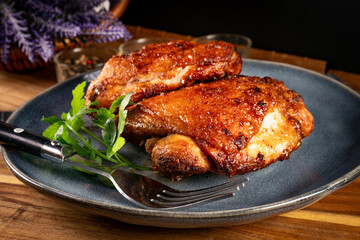 Two baked pieces of chicken.