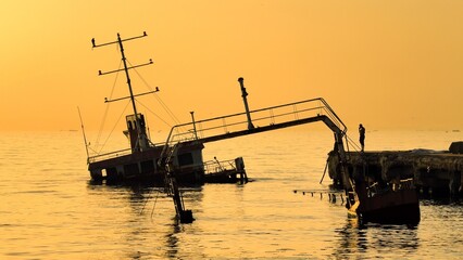 A shipwreck in calm Marmara Sea near Istanbul, Turkey. The rusted structure leans in the water with...